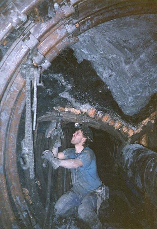 A miner is working in a roadway underground !